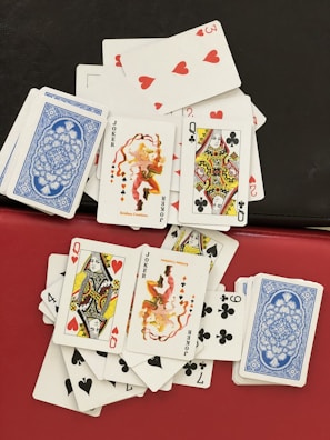 A colorful spread of greedy hands cards laid out, showing a mix of assets and points.