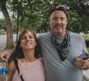 man in gray crew neck shirt standing beside woman in pink tank top