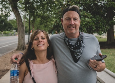 man in gray crew neck shirt standing beside woman in pink tank top