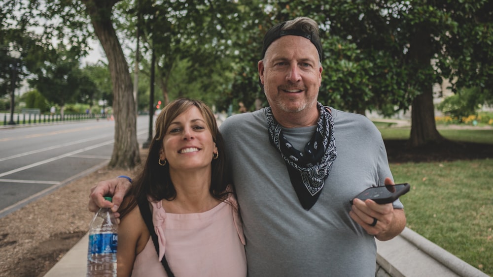 man in gray crew neck shirt standing beside woman in pink tank top