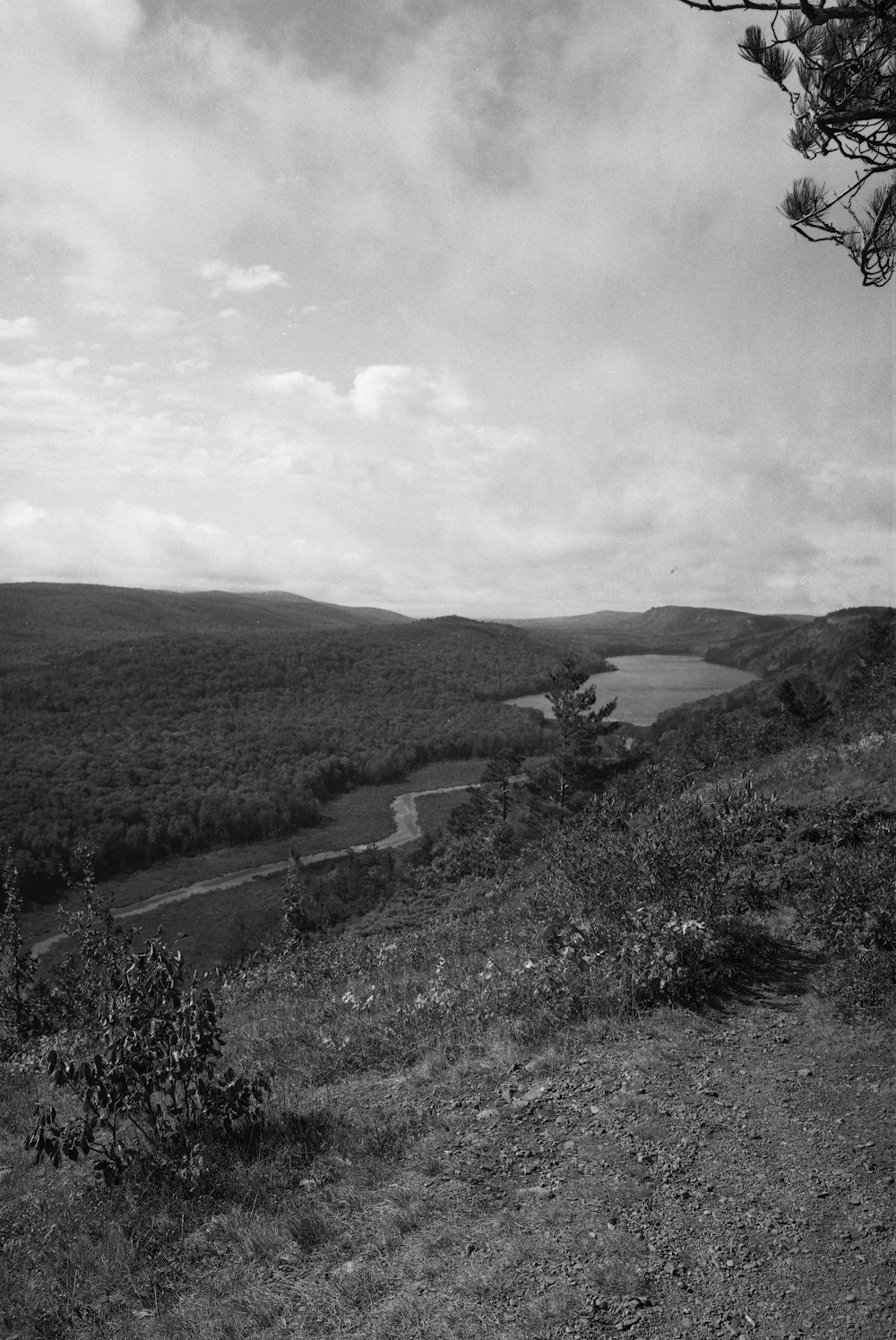 grayscale photo of mountain under cloudy sky