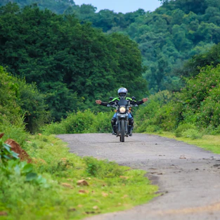 man riding motorcycle on road during daytime