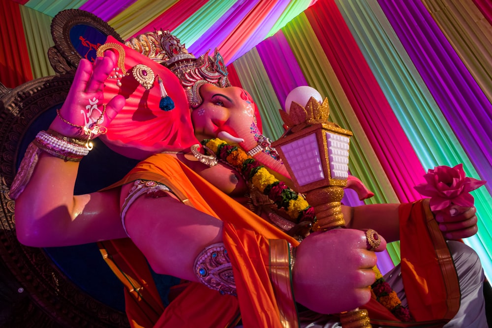 hindu deity figurine in red and gold dress