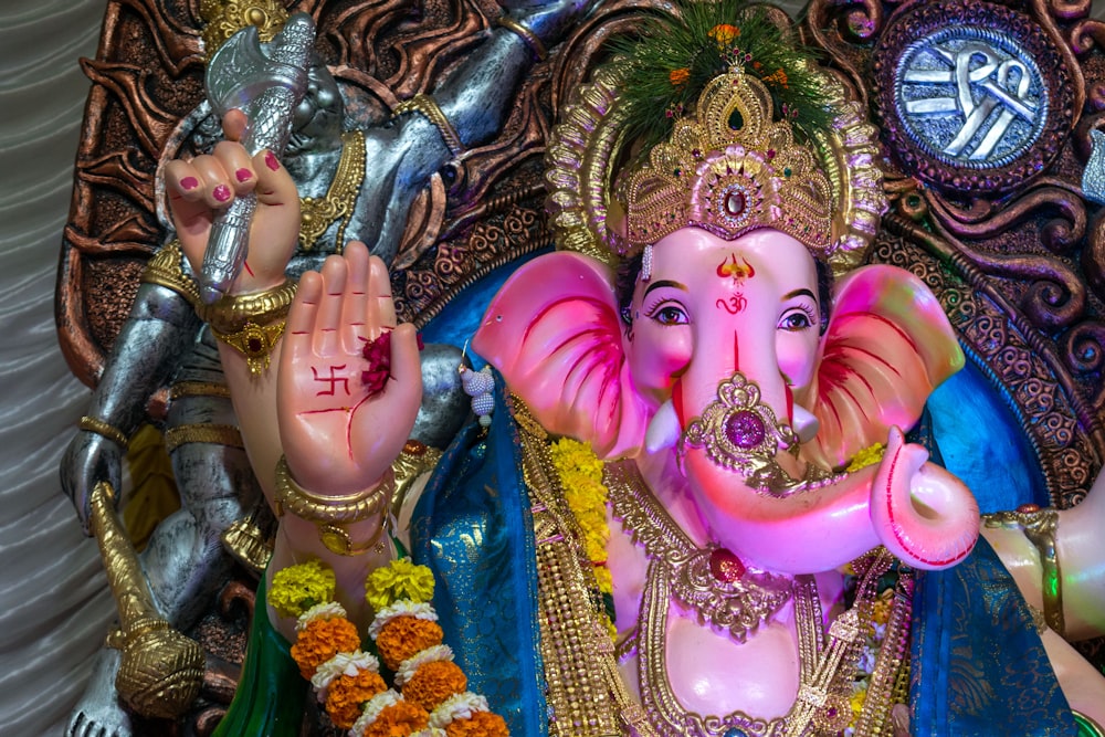 hindu deity figurine on blue textile