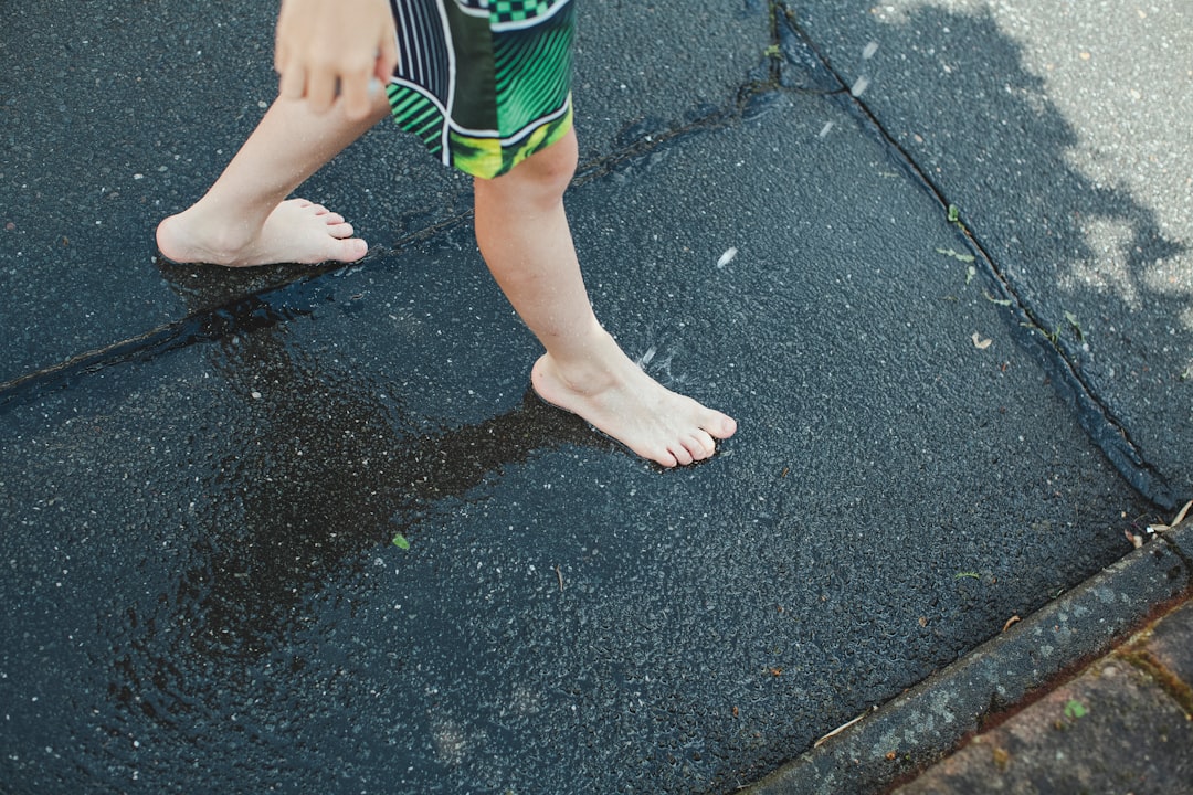 child in green and white stripe shorts