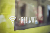 WiFi signal icon subtly integrated into a grey and white textured background.