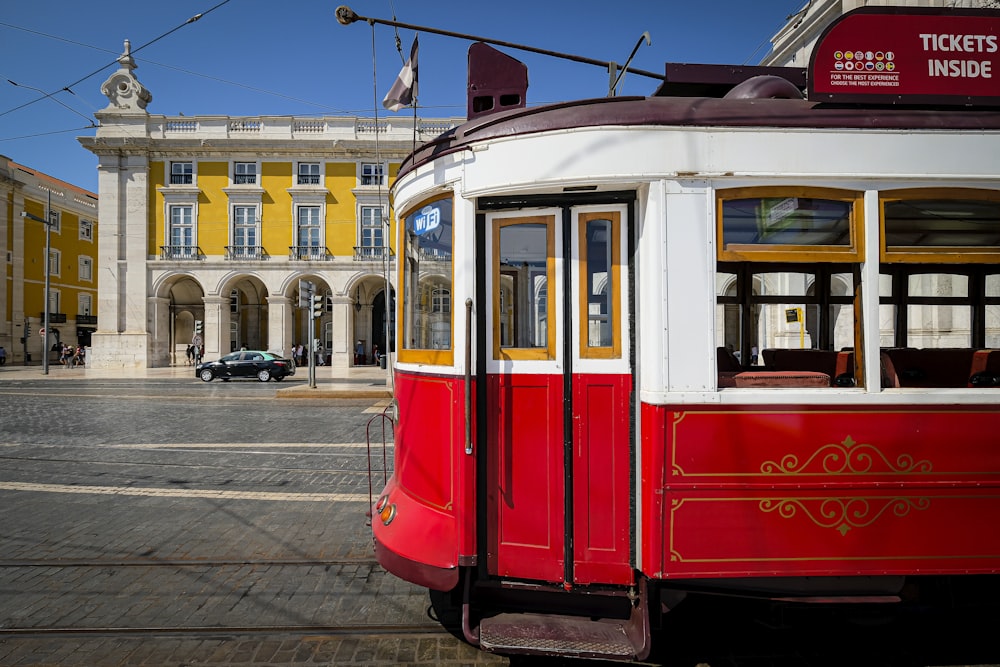 red and white tram on the street