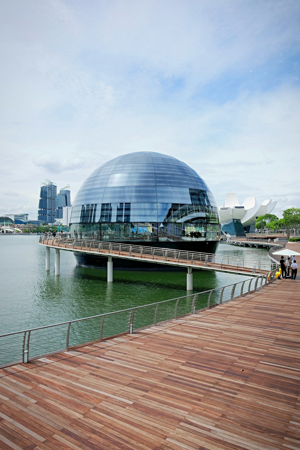 glass building near body of water during daytime