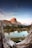 brown mountain near body of water during daytime