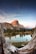 brown mountain near body of water during daytime