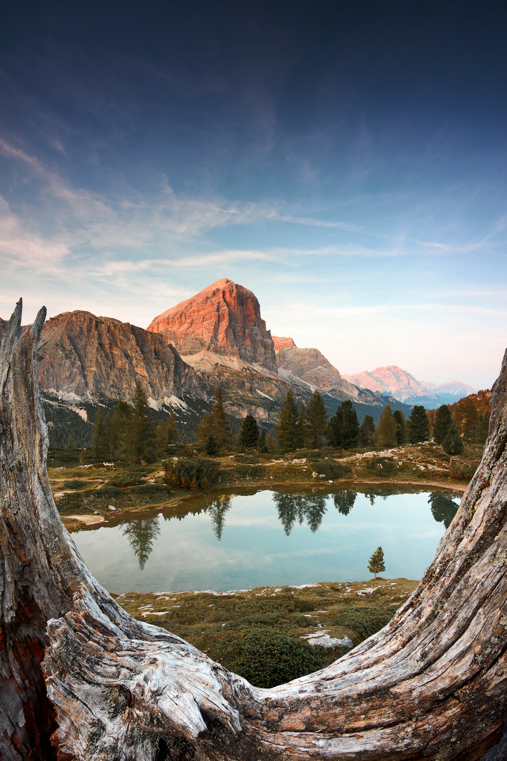 brown mountain near body of water during daytime