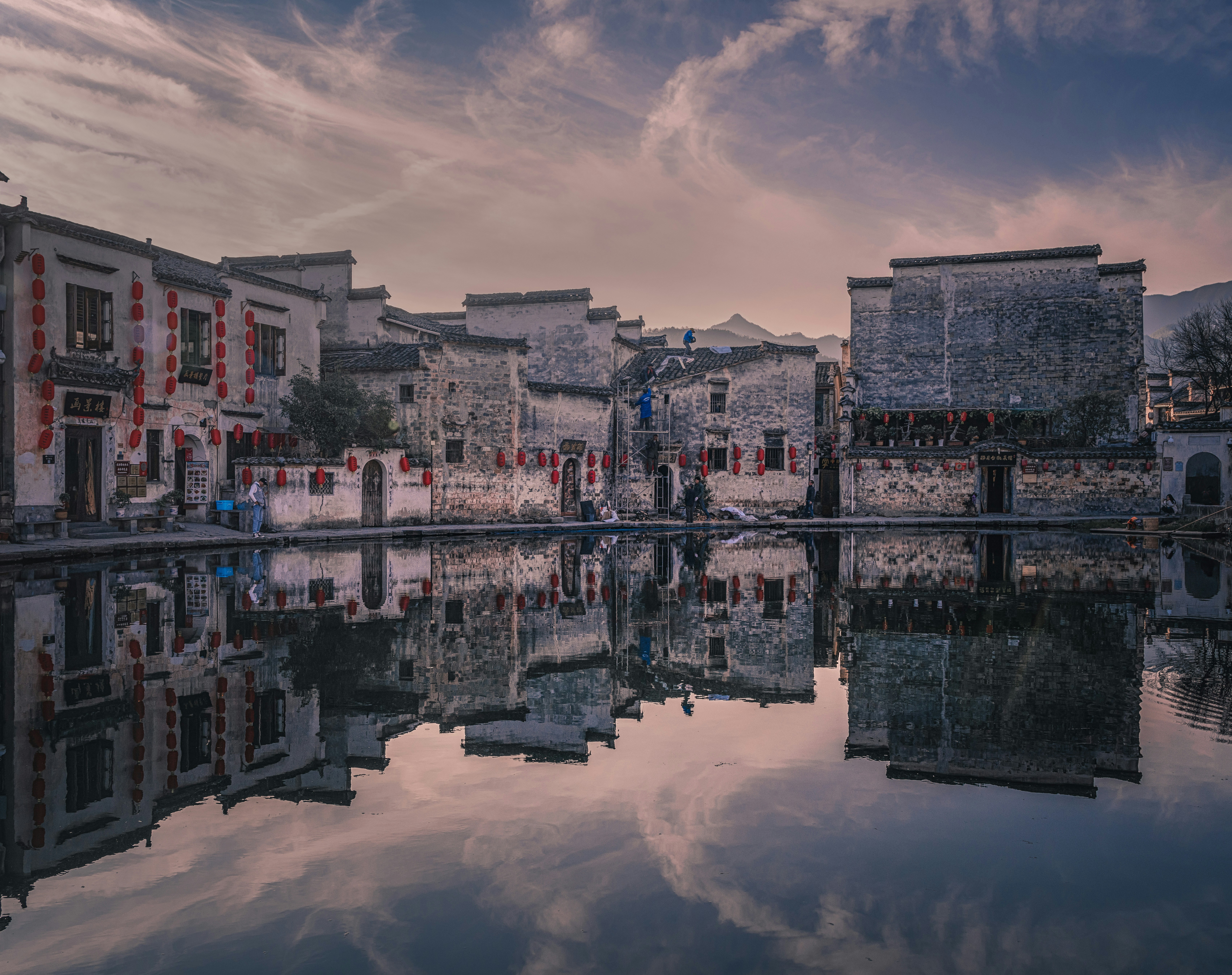 Bhutanese dzong fortress reflected in a still mountain lake at dusk — ancient architecture, sacred landscape, deep silence