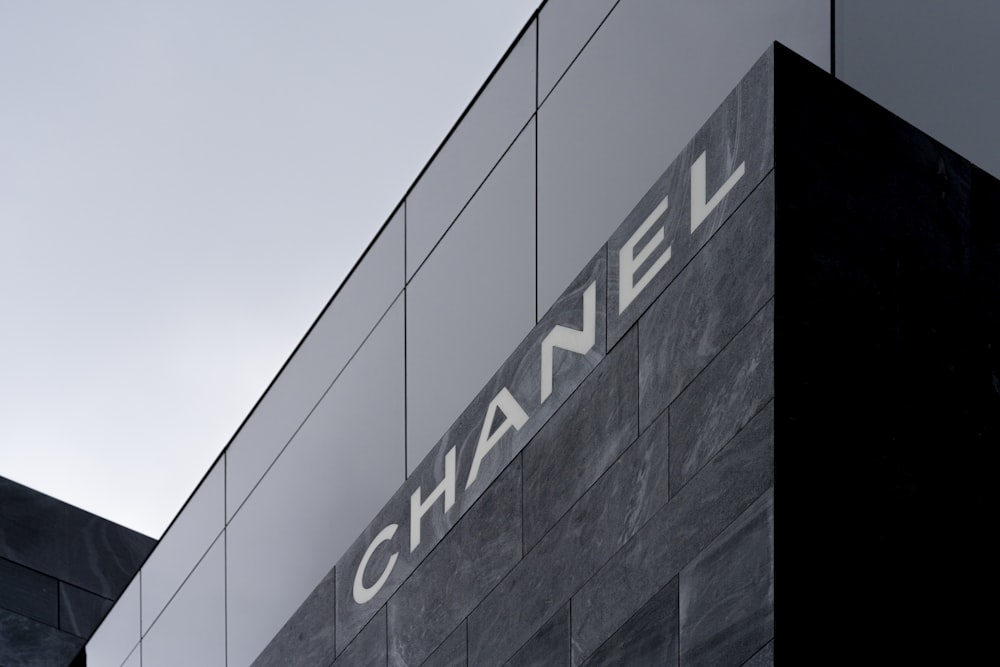 a black and white photo of a building with the word chanel on it