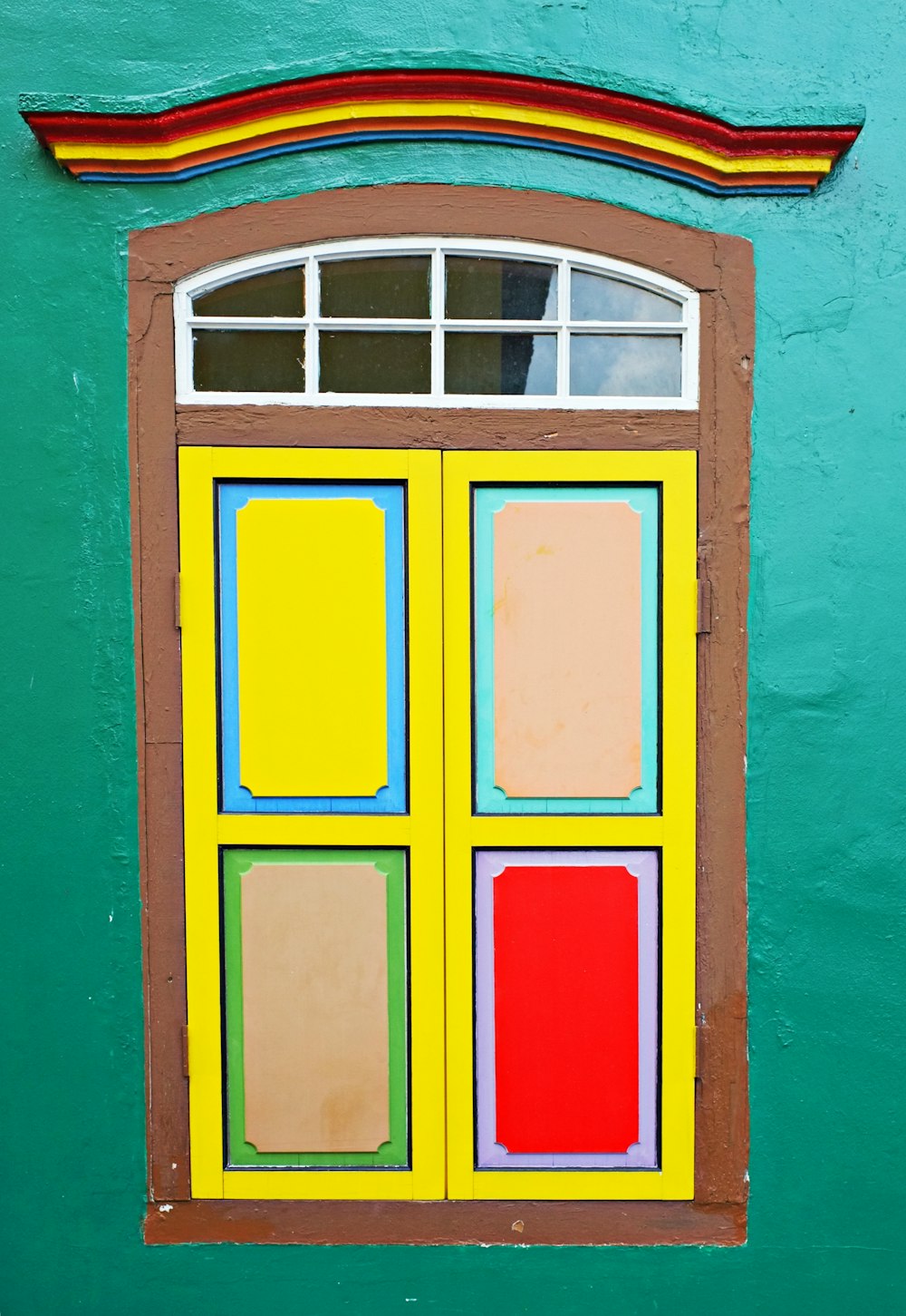 red yellow and green wooden window frame