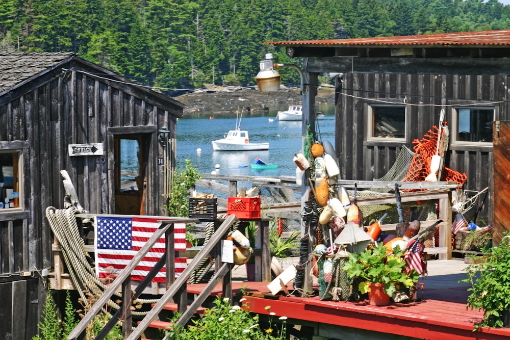 people in brown wooden house near body of water during daytime