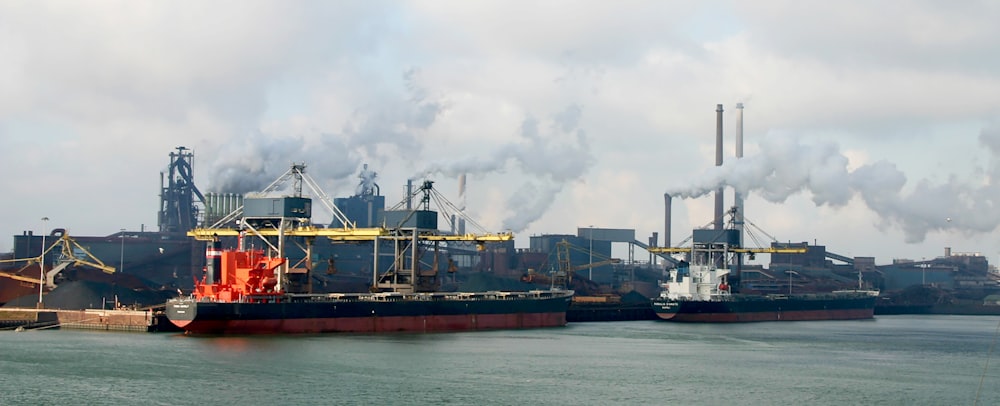 red and white ship on sea under white clouds during daytime