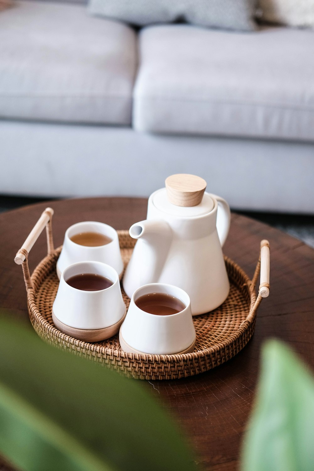 white ceramic mugs on brown woven basket