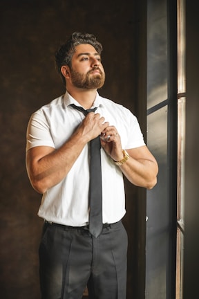 man in white button up shirt and black pants