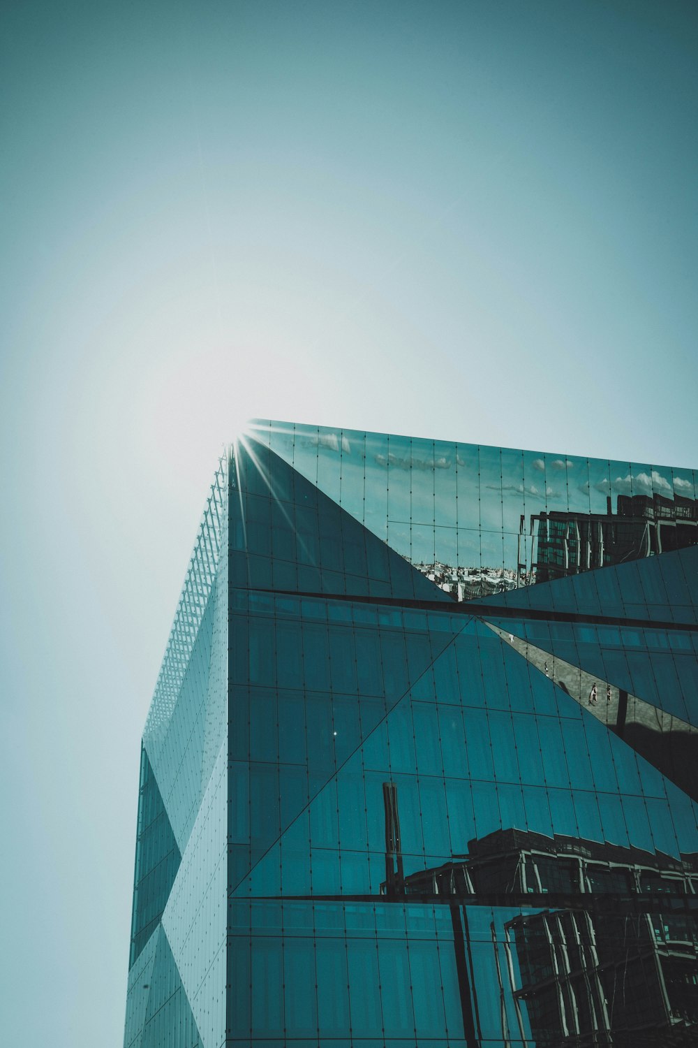 blue glass walled high rise building