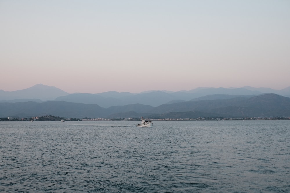 white boat on sea during daytime