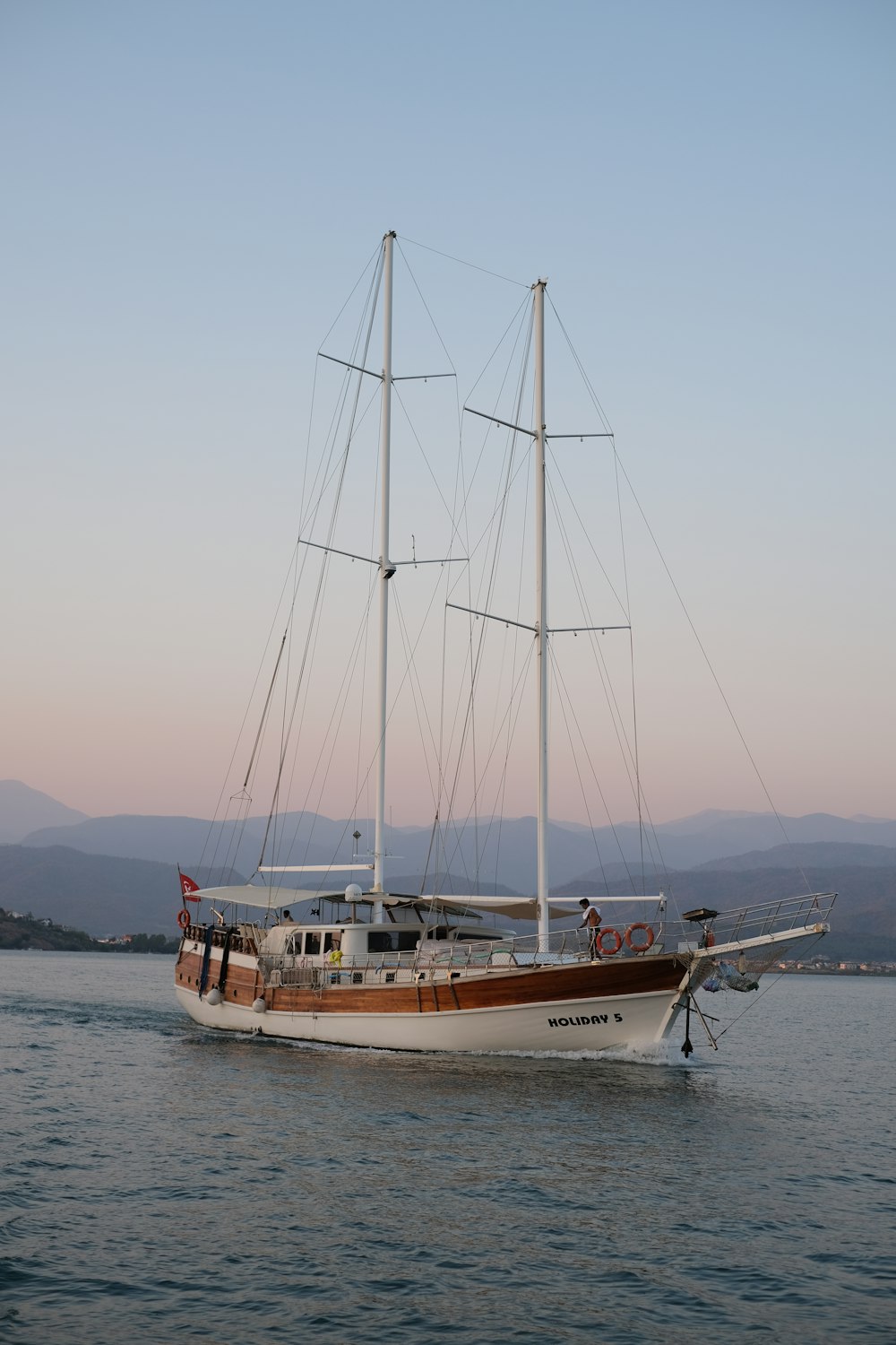 white and brown boat on sea during daytime