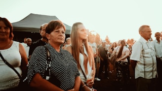 Couples enjoying a relaxed outdoor swinger gathering at sunset.