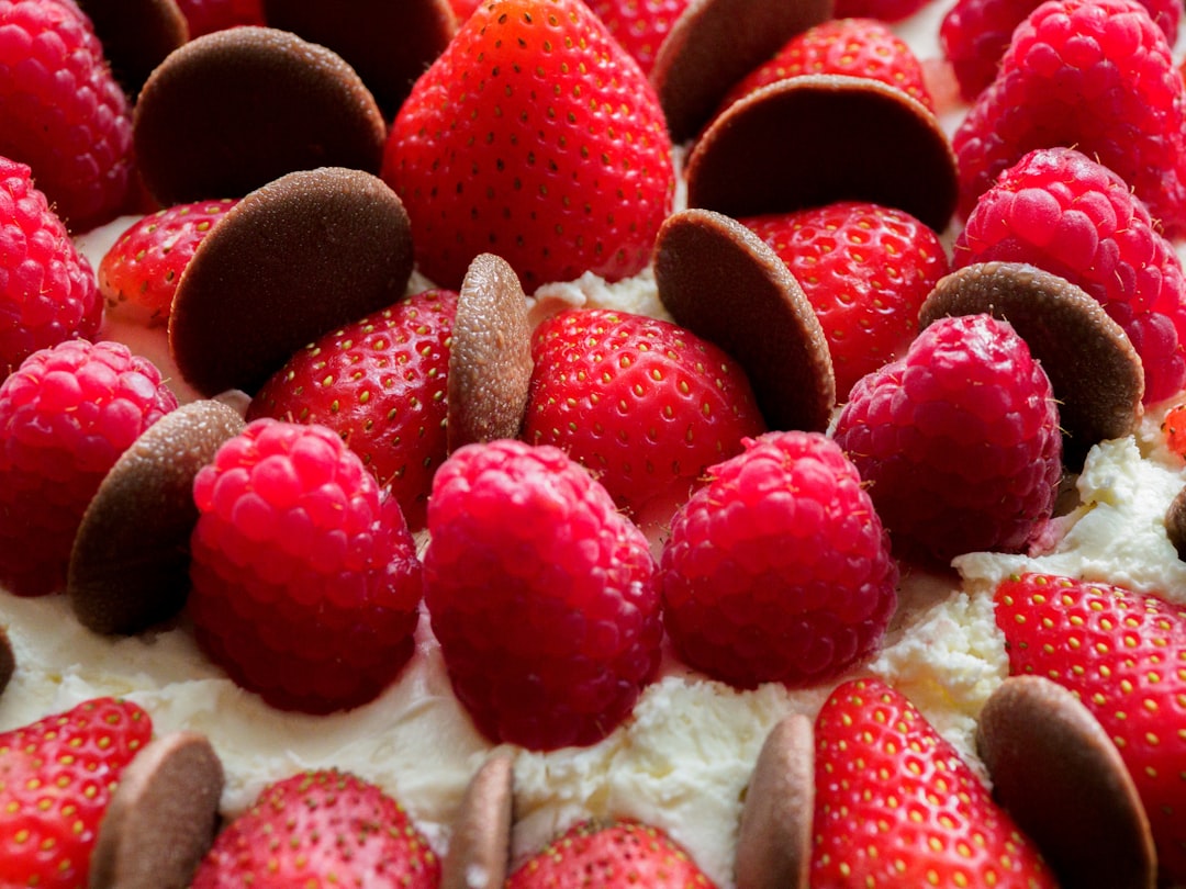 red and white raspberry on white ceramic plate