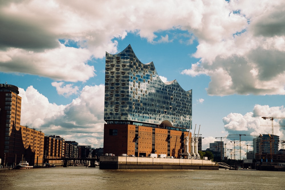 white and black concrete building under white clouds during daytime