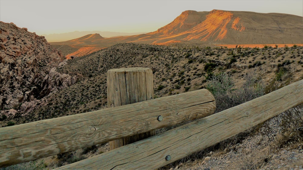 brown wooden bench on brown mountain during daytime