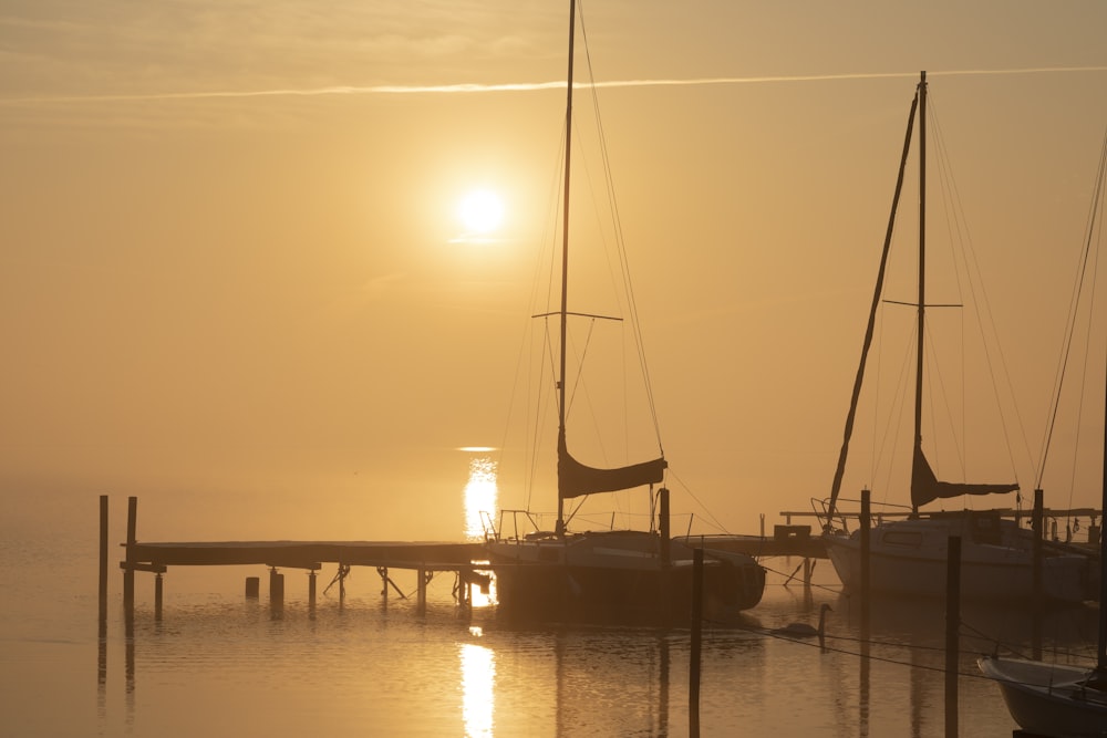 silhouette of boat on sea during sunset