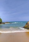 brown rock formation on sea shore during daytime