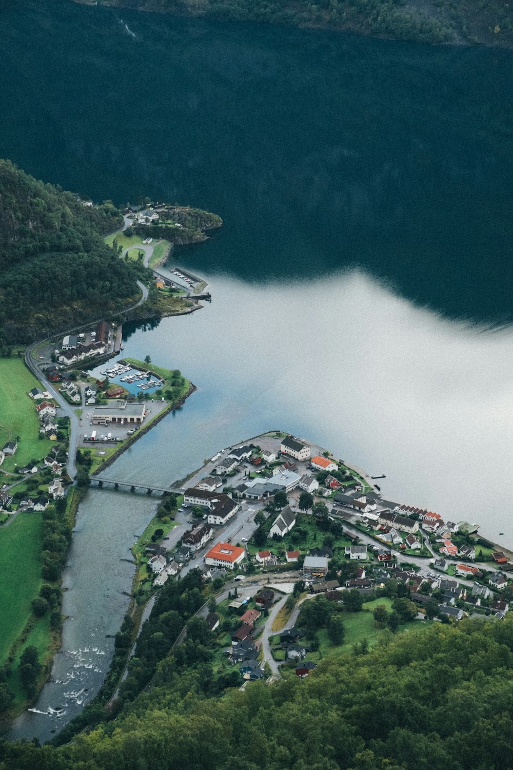 aerial view of city near green mountain during daytime