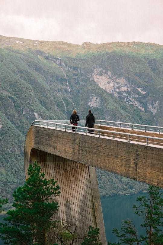 man and woman kissing on bridge during daytime in Aurlandsfjord Norway