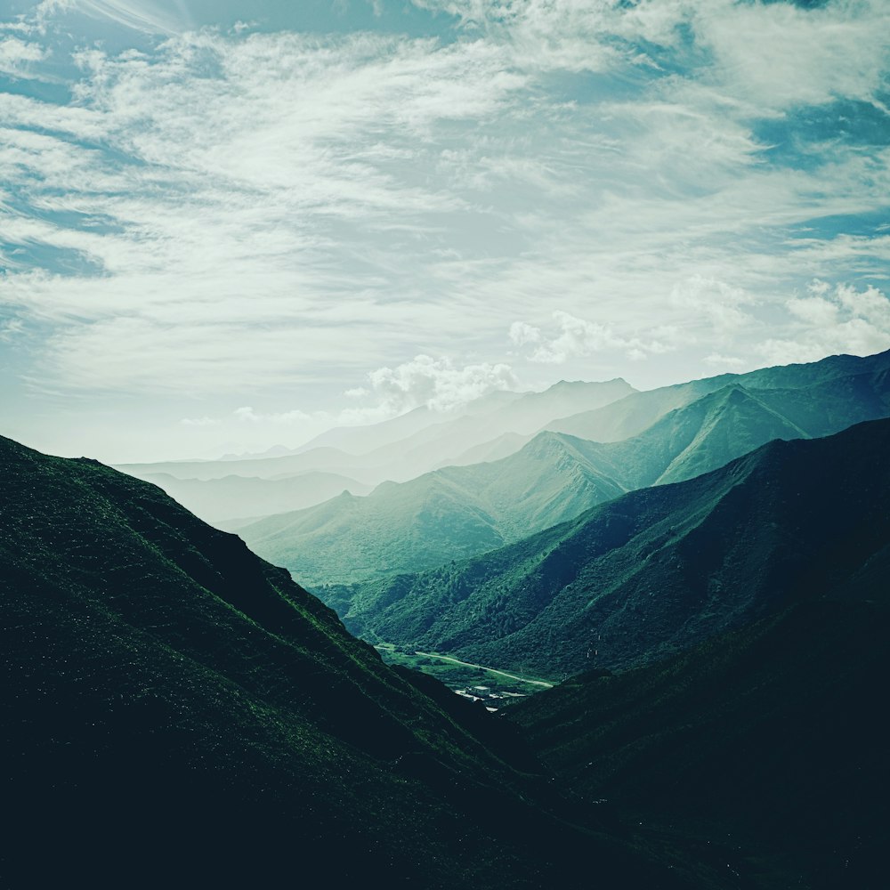 green mountains under white clouds during daytime