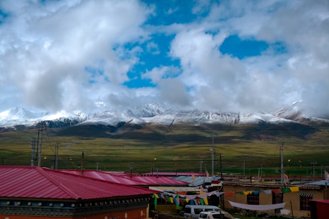 white and red tent under white clouds and blue sky during daytime