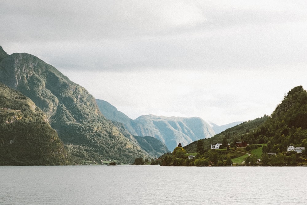 green mountains beside body of water during daytime