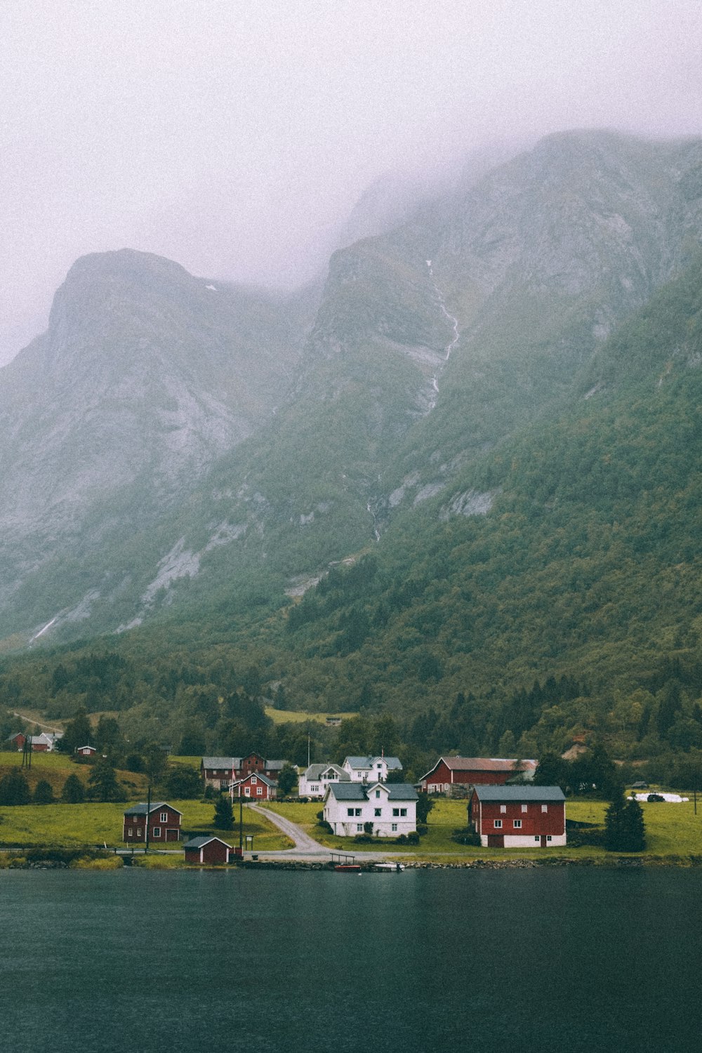 green grass field near mountain during daytime