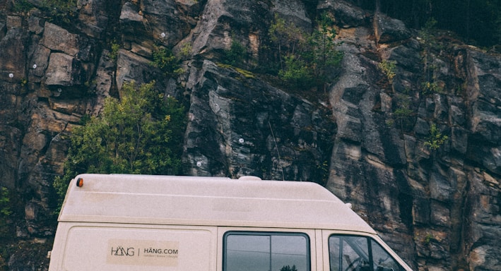 white van parked near mountain