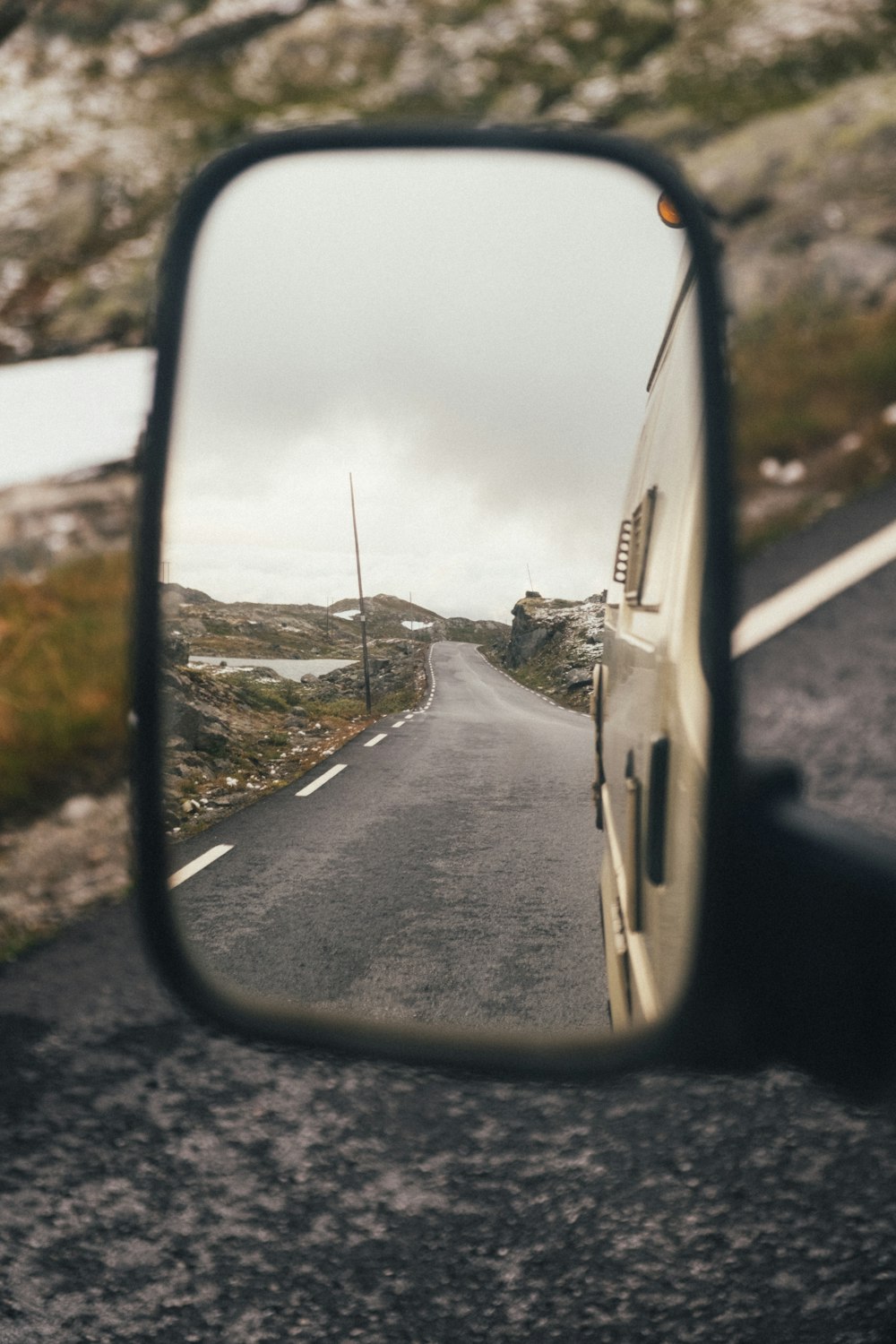 car side mirror showing white car