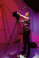 A professional photographer adjusting camera settings at a corporate event.