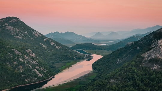 lake between mountains during daytime in Rijeka Crnojevića Montenegro