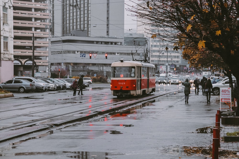 red and white tram on road during daytime