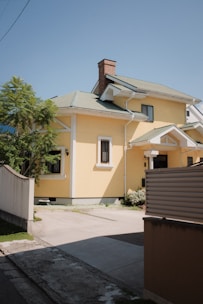 Exterior of a two-story house with a small garden and driveway.