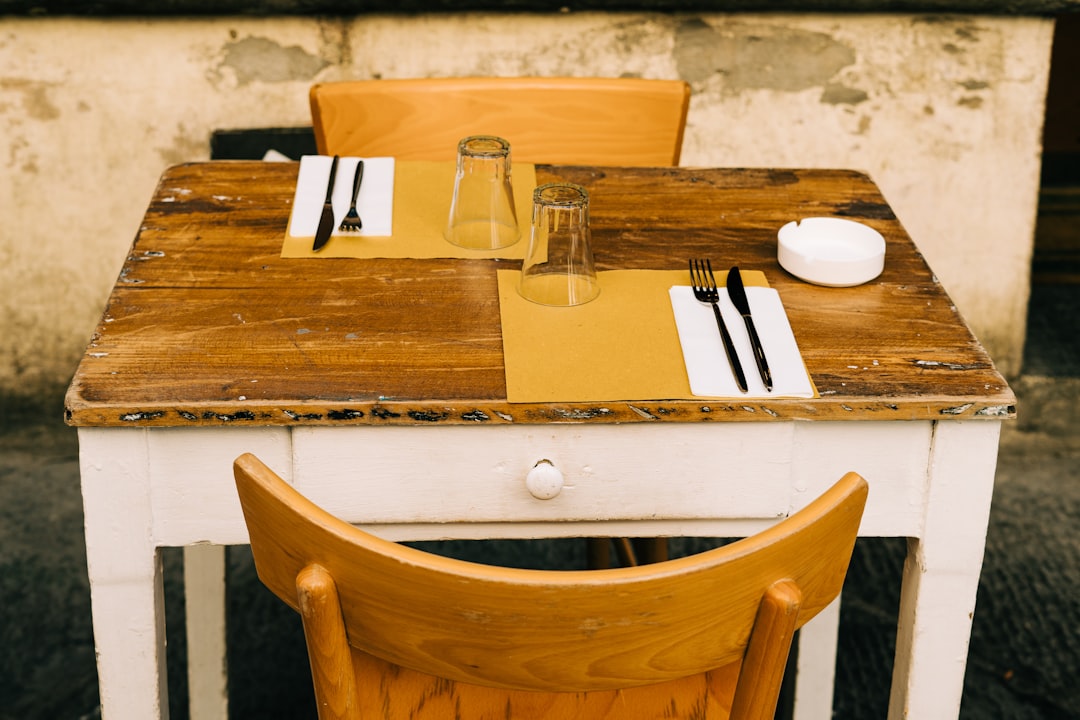 brown wooden table with brown wooden chair, A table for two set in a rustic manner