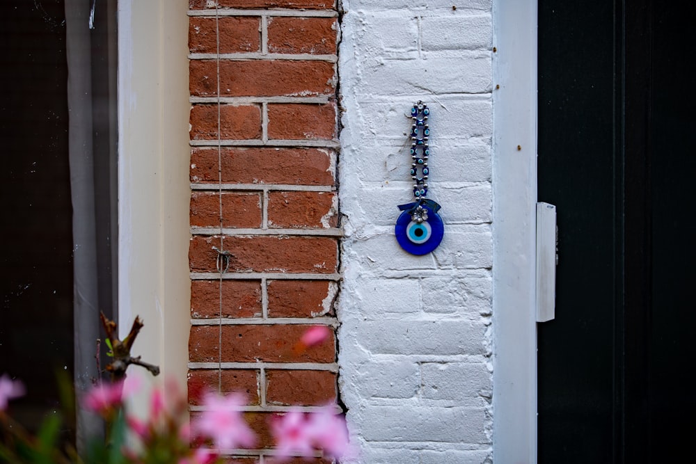 purple flower on brown brick wall