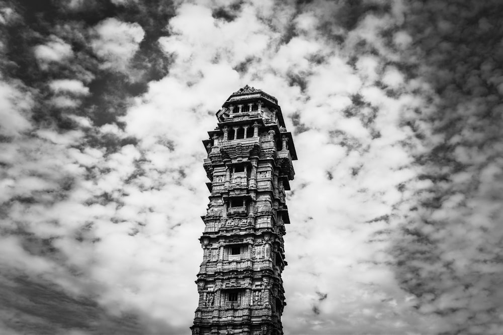 grayscale photo of concrete building under cloudy sky