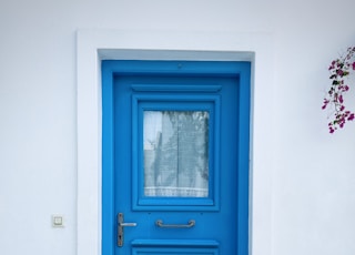 blue wooden door with white wooden frame