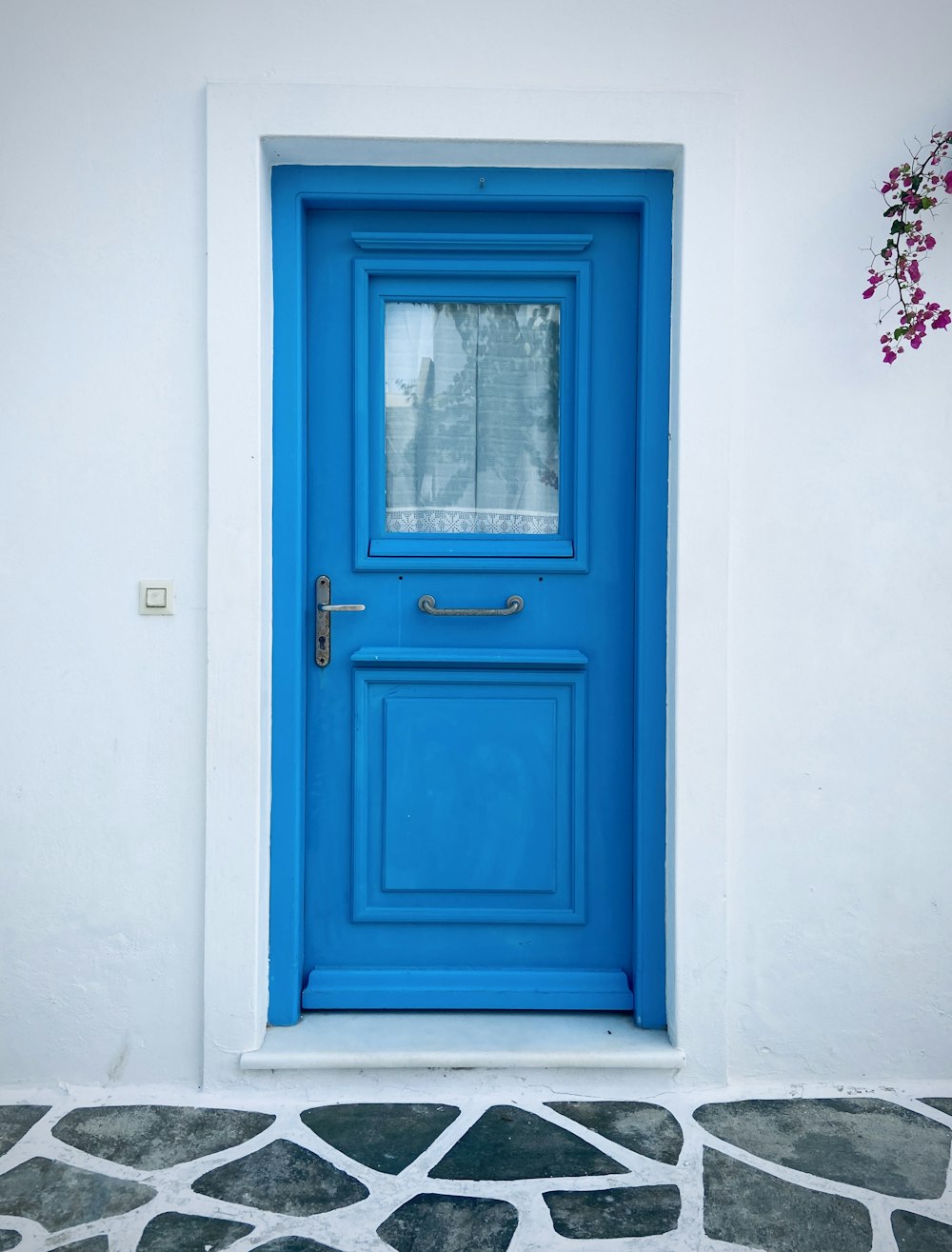 blaue Holztür mit weißem Holzrahmen
