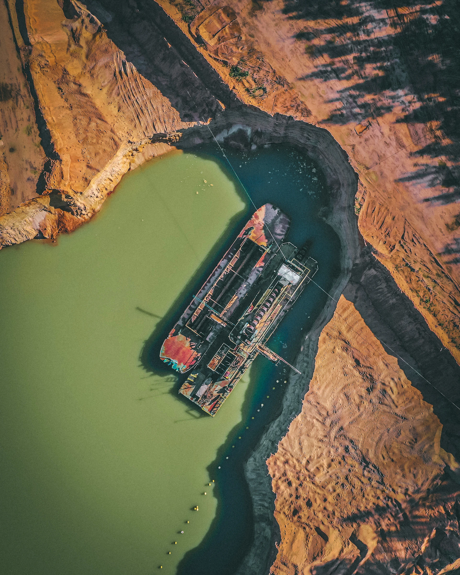 aerial view of red and white train on brown rocky mountain during daytime