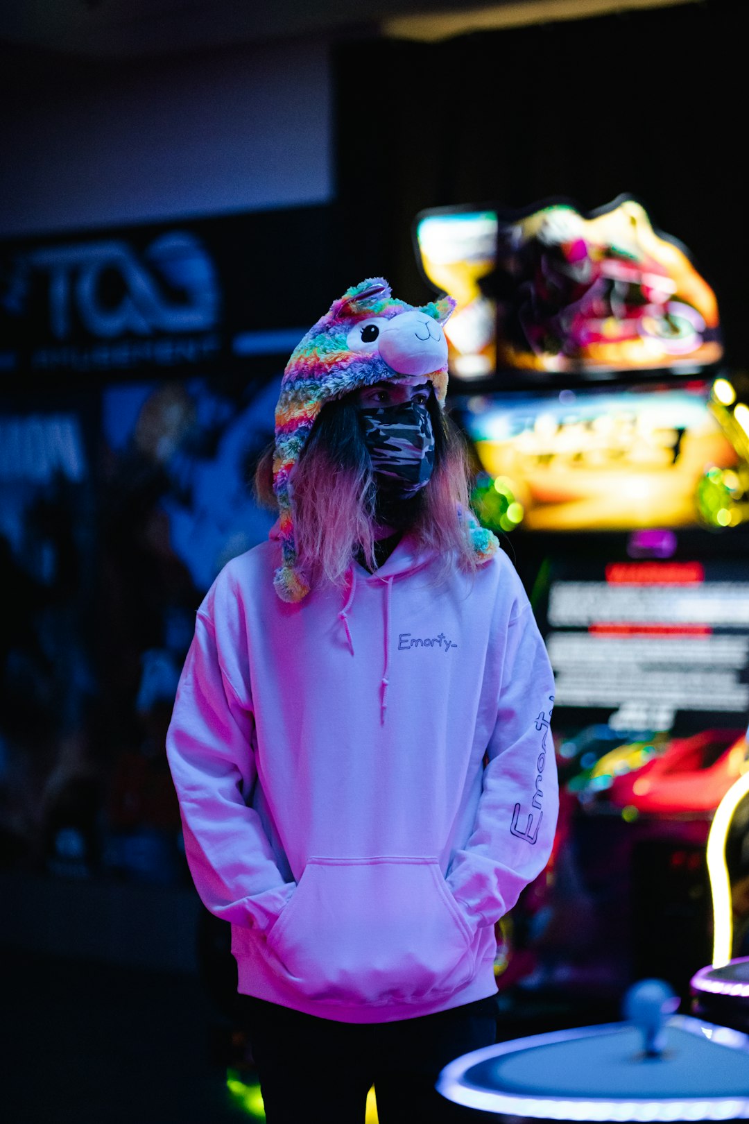 woman in pink hoodie standing near store
